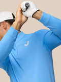 Back view of a golfer wearing a light blue Castore top with a white cap and Castore logo on the back