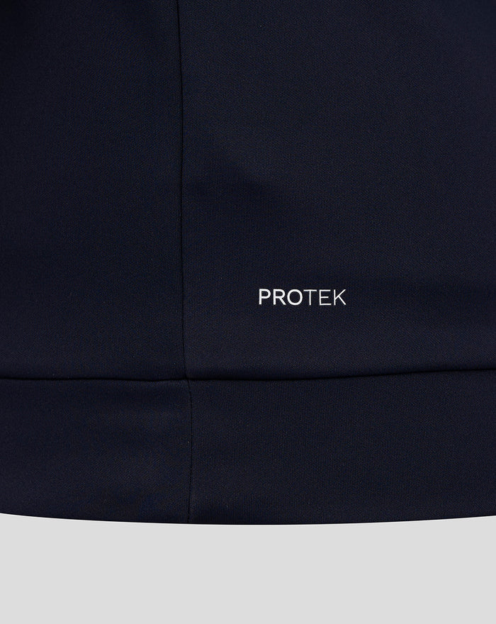 Close up of navy fabric with PROTEK branding for CLUB CLASSIC QUARTER ZIP