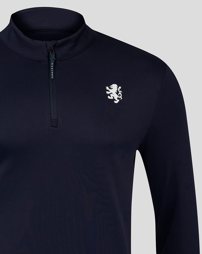 Close-up of navy quarter zip showing the chest logo and a short vertical zipper.