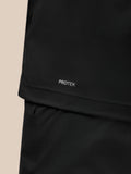 Male model wearing black Pinnacle Gilet over a pink T-shirt, full-body view.