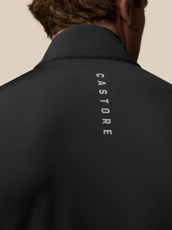 Close up of the black Pinnacle Gilet back with Castore branding running vertically and a wing logo on the collar.