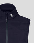 Close-up of navy gilet collar and vertical zipper with a white lion crest on the left chest.