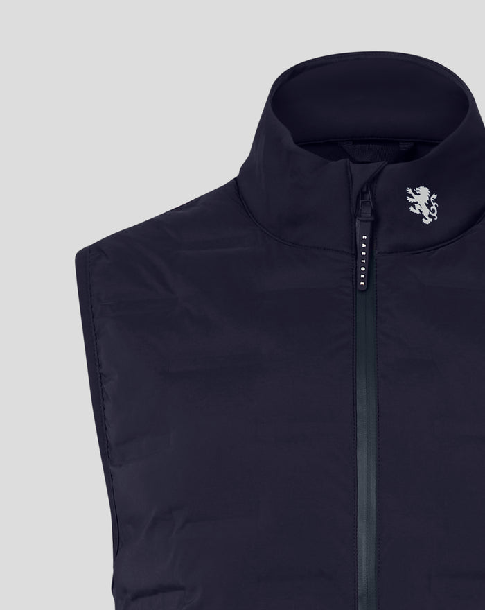 Detail of the navy gilet neck area showing the white lion crest near the zipper and dark collar lining.