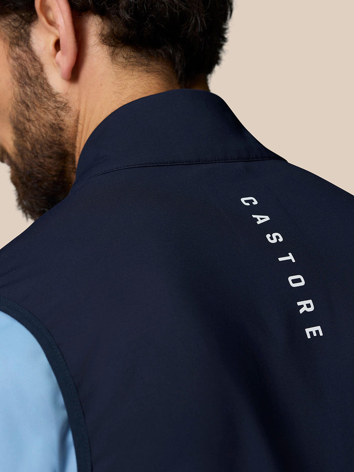 Close-up of the navy collar showing the Castore wing logo on dark fabric near the neck