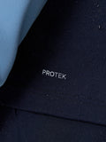 Close-up of navy golf gilet fabric with water droplets and Protek branding