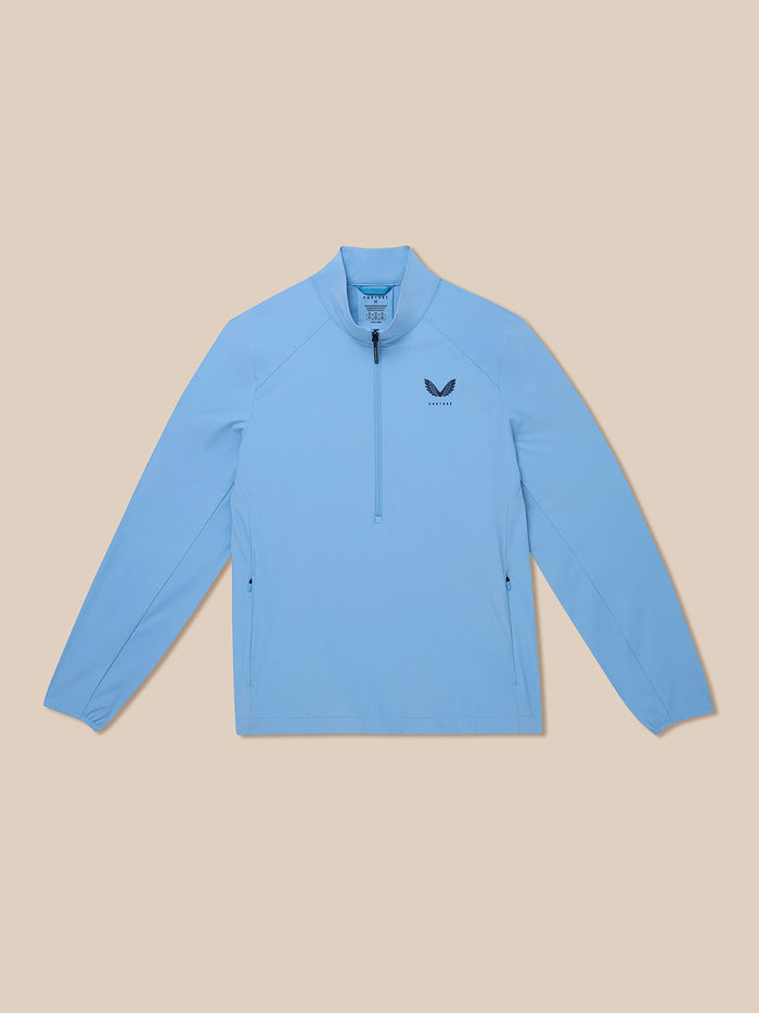 Model wearing sky blue Golf Flex Jacket with half zip front and chest logo