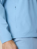 Close up of sky blue jacket side seam with a vertical zip pull and clean stitching.