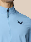 Back view detail of sky blue golf jacket showing vertical back vent and Castore logo.