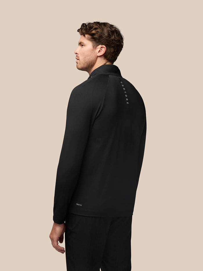 Back view of black Golf Pinnacle Jacket showing quilted front panels and Castore branding along the back of the neck
