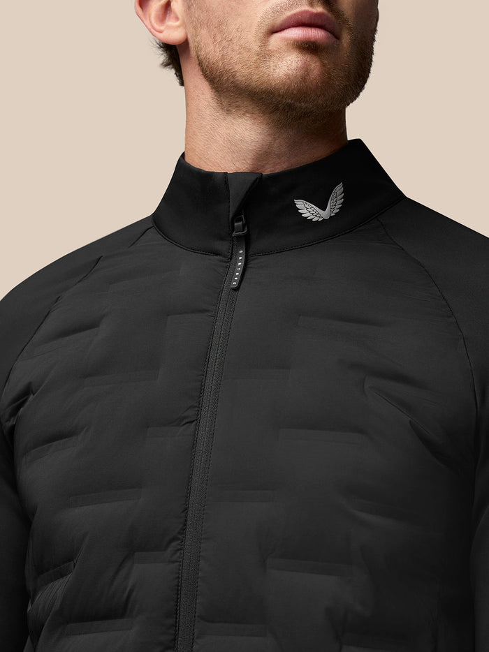 Close up of black Golf Pinnacle Jacket showing stand collar, front zipper and wing logo at the neck.