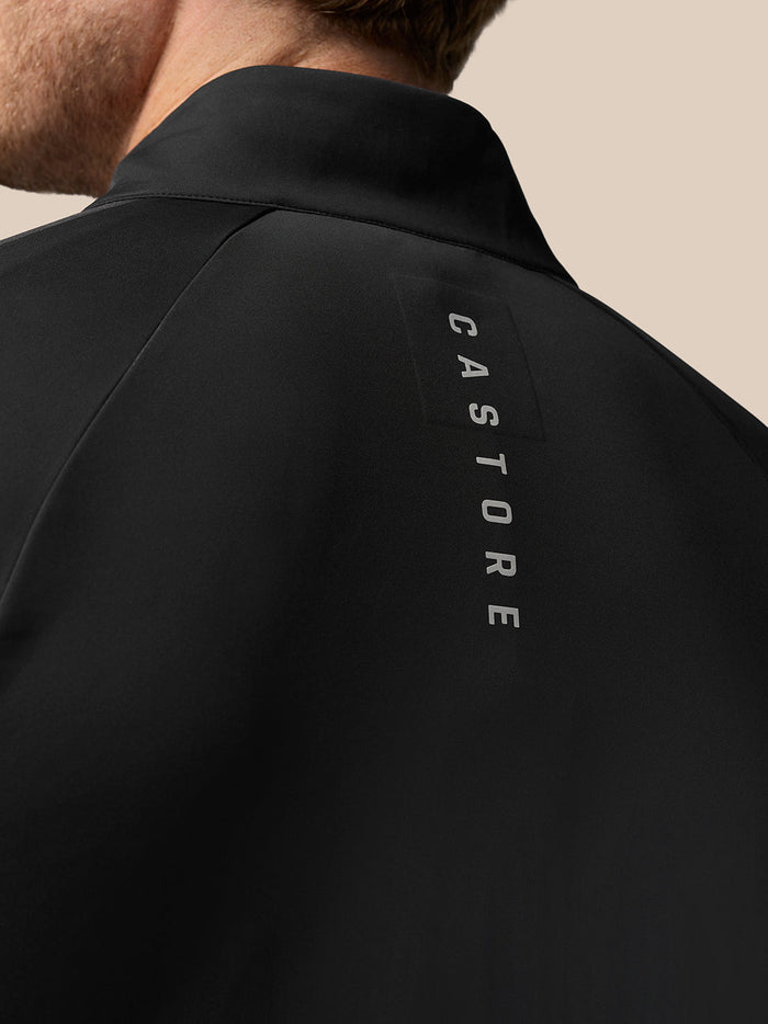 Back view of the black Golf Pinnacle Jacket with vertical CASTORE branding along the upper back.