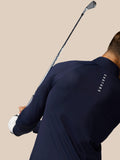 Back view of navy golf pinnacle jacket worn by a golfer with raglan sleeves and stand collar
