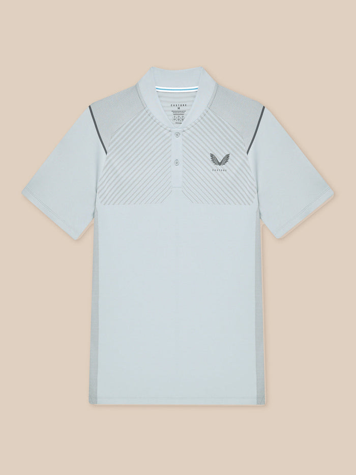 Flat lay of light grey Pinnacle Golf LVS polo showing diagonal chest stripes and left chest logo.