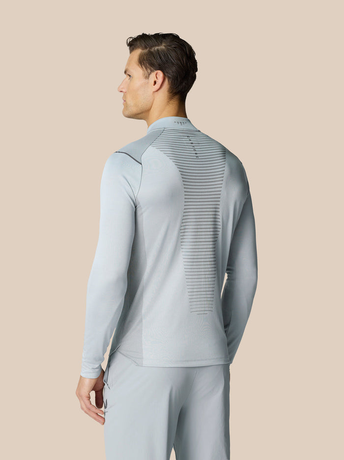 Back view of Pinnacle LVS 1/4 Zip Top in mid grey with striped back panel and logo on upper back
