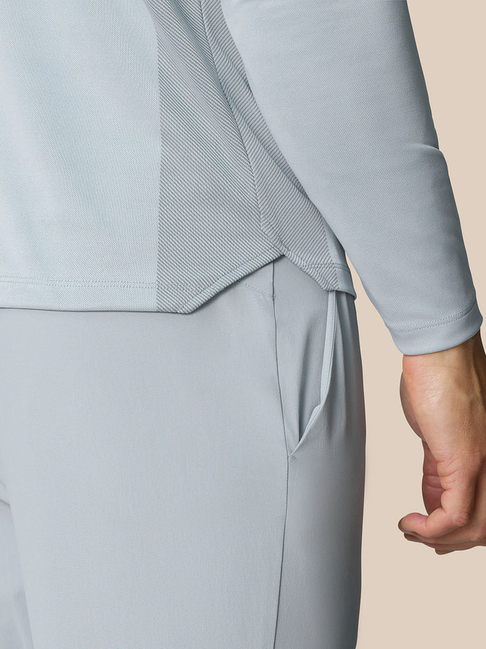 Back view close up of mid grey Pinnacle LVS 1/4 Zip Top showing textured knit panels and side vent detail