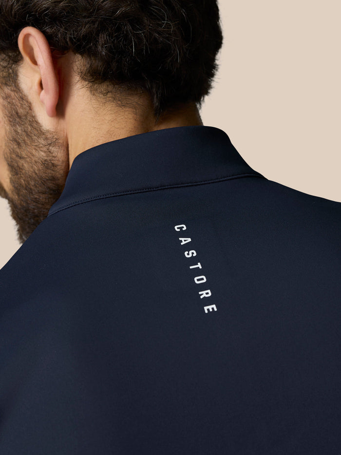 Back view of navy gilet collar with CASTORE branding along the upper back.