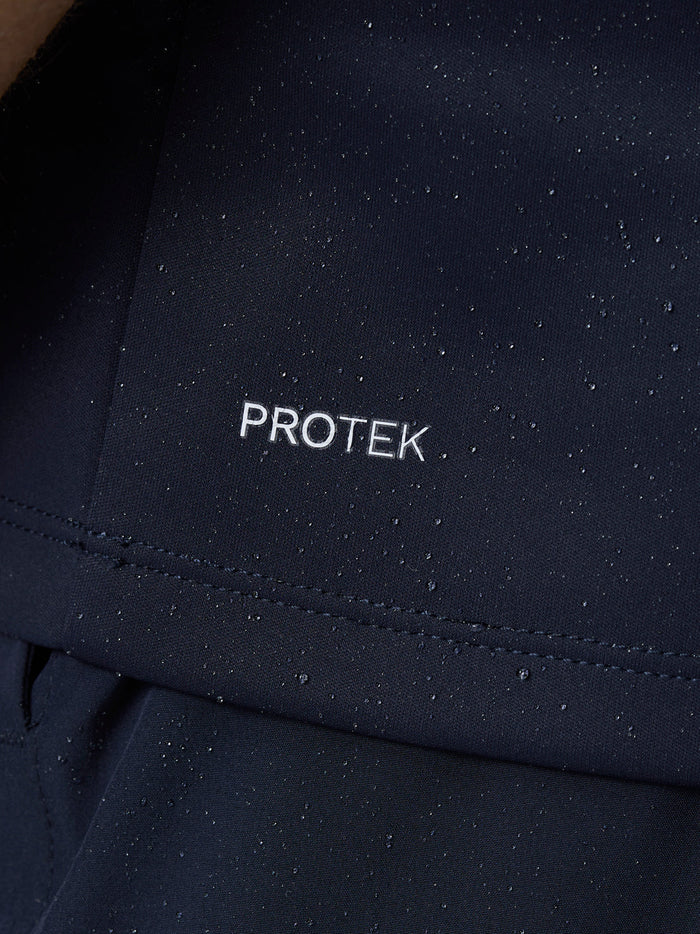 Close up of navy fabric showing PROTEK water resistant finish with droplets.