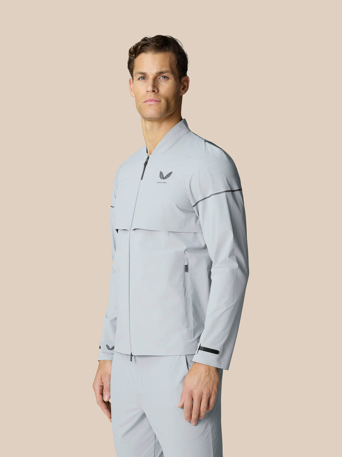 Male model wearing Golf Pinnacle LVS Woven Jacket in mid grey front view.