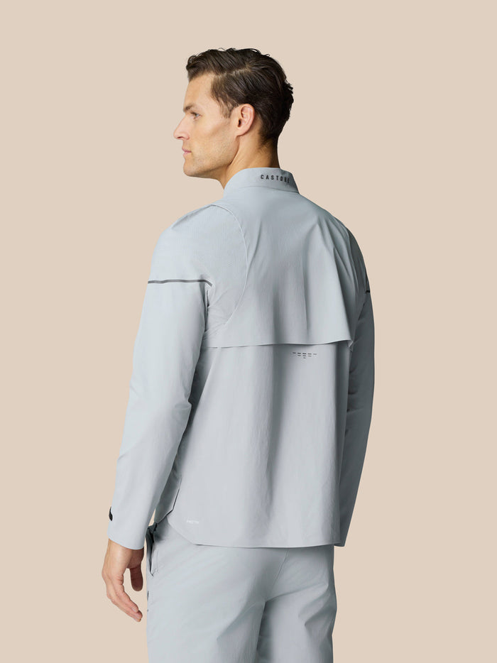 Back view of mid grey Golf Pinnacle LVS Woven Jacket showing vented back and Castore logo on collar.