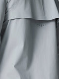 Close-up of back panel on light grey Golf Pinnacle LVS woven jacket showing venting and seam details.