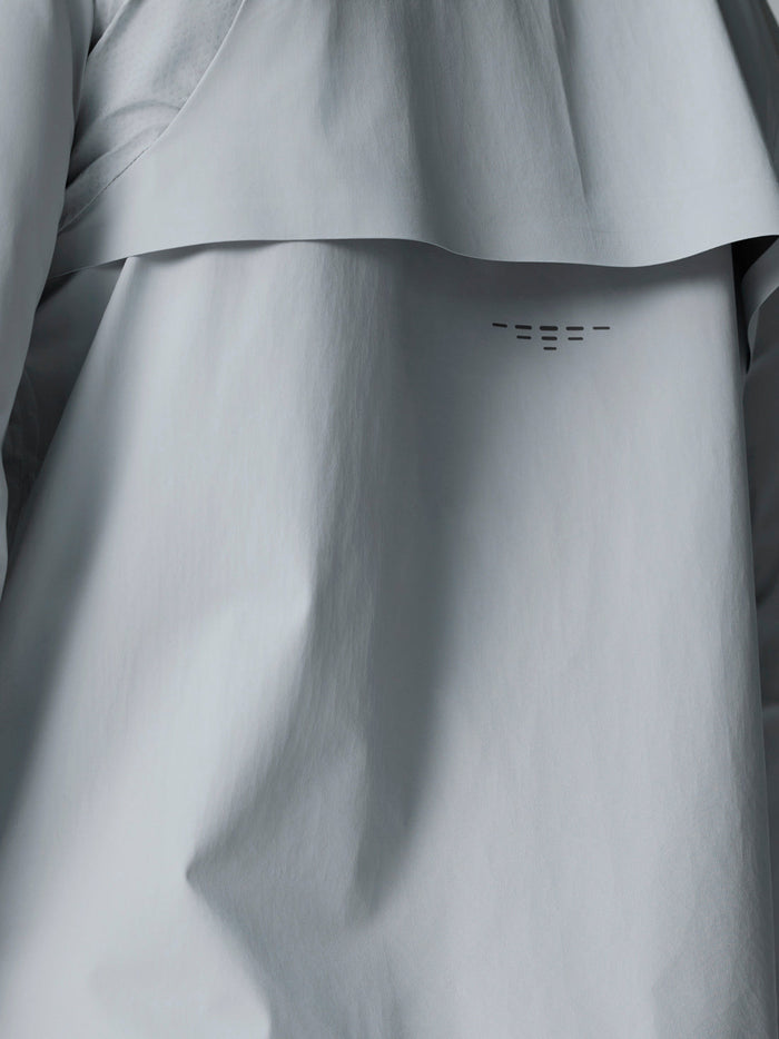 Close-up of back panel on light grey Golf Pinnacle LVS woven jacket showing venting and seam details.