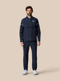 Full body shot of a man wearing the midnight navy Golf Pinnacle LVS Woven Jacket with zip front and white sleeve piping.