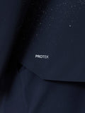 Close up of midnight navy ProTek fabric with water droplets on a golf jacket.