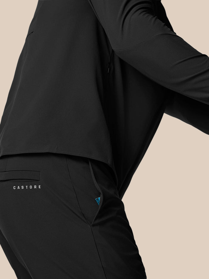 Close up of black Castore golf winter trouser showing back pocket with Castore branding and fabric texture