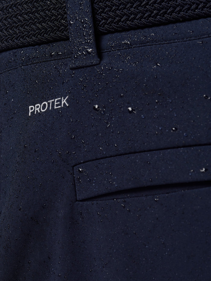 Close-up of navy ProTek water resistant fabric with a waist panel on Golf Pinnacle Winter Trousers