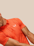 Close up of bright orange striped polo fabric with white left chest logo on model’s chest