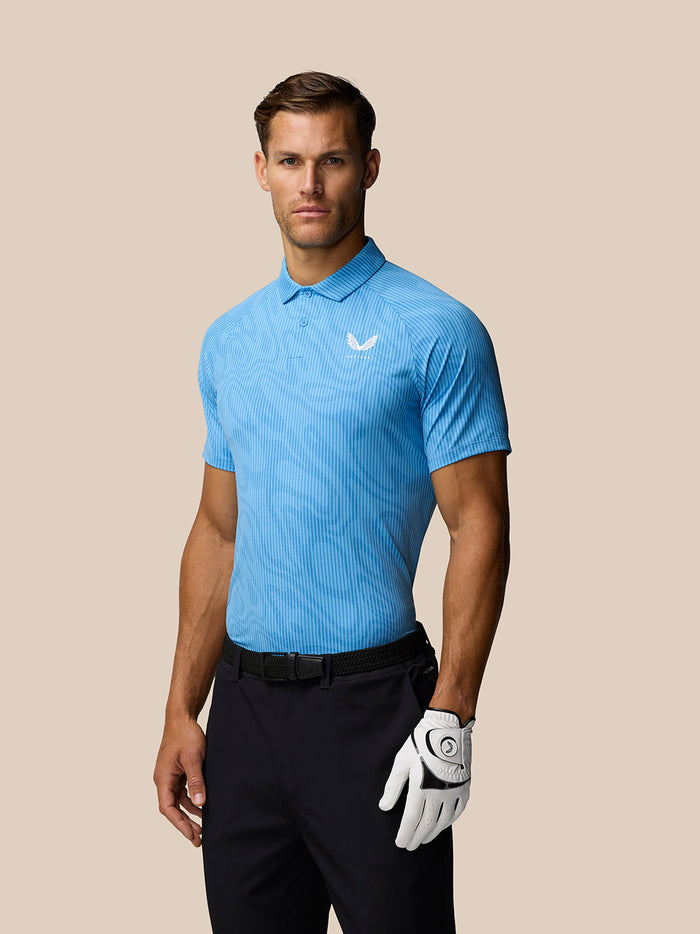 Man wearing cool blue striped golf polo with three button placket and Castore logo on chest