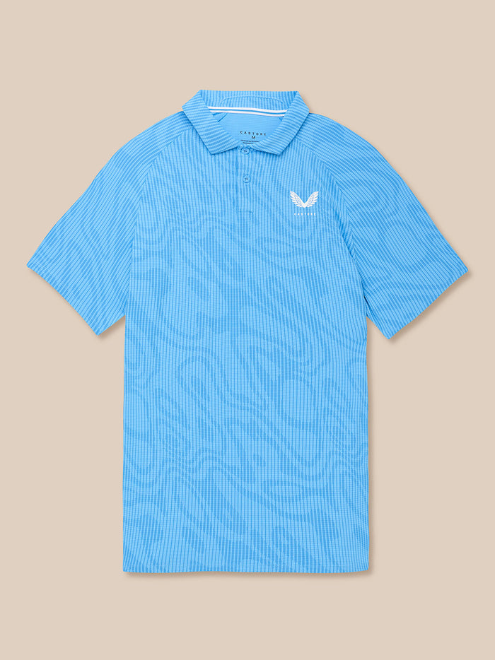Flat lay of cool blue glow printed golf polo with white Castore logo on left chest.