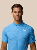 Front view of a man wearing a light blue Glow Printed Polo with a small left chest logo.