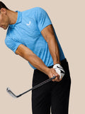 Golfer in blue Glow Printed Polo mid swing with striped knit fabric and left chest Castore logo