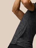 Close-up of gunmetal mid grey Golf Club Glow Printed Polo showing subtle striped pattern and AerTek label at the hem.