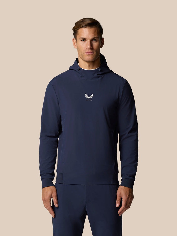 Male model wearing midnight navy golf performance hoodie with three panel hood and chest logo