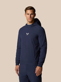 Three-quarter view of a man in midnight navy golf pinnacle hoodie showing the logo on the chest.