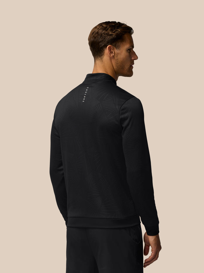 Back view of the black debossed golf club top with Castore branding along the back.