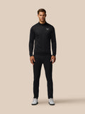 Male model wearing black golf club classic quarter-zip debossed top with all-over print.