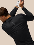 Male golfer in a black Golf Club Classic quarter-zip top with all-over print; Castore branding on back and left chest.