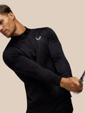 Side view of a man in black golf club classic quarter-zip top showing the zip and subtle embossed pattern.