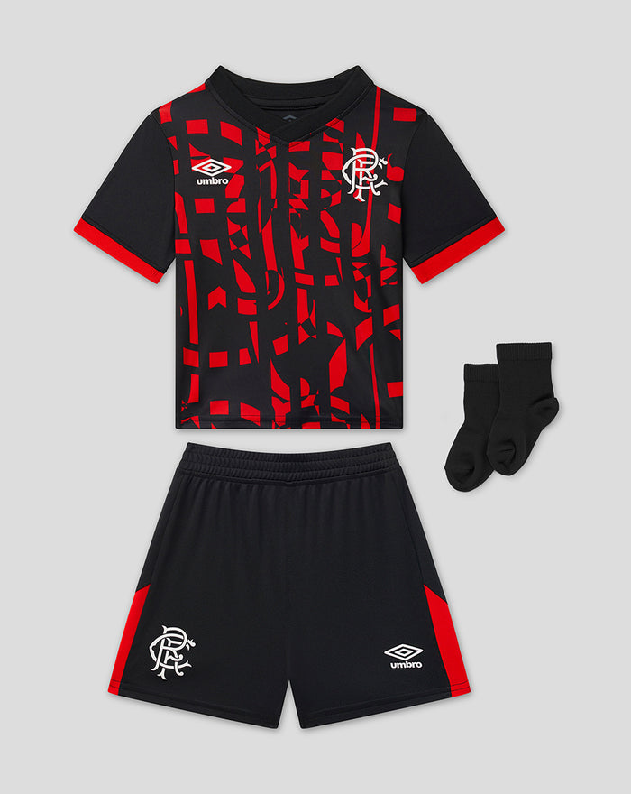 Rangers 2026/27 third baby kit laid out with shirt shorts and socks showing bold red graphic pattern and crest