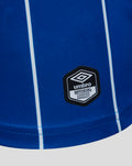 Close-up of blue Rangers shirt fabric showing the Umbro official licensed product badge