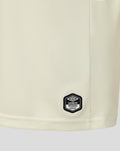 Off-white Rangers junior away shirt with blue detailing; close-up of fabric and Umbro official patch near the hem