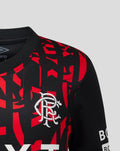 Rangers FC junior third shirt chest area showing white Umbro double diamond logo on a black red graphic pattern