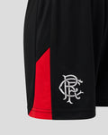 Close up of black Rangers FC junior shorts showing white embroidered crest near the hem with a red side panel.