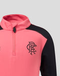 Close-up of coral pink Rangers FC training top with navy sleeves and chest crest.