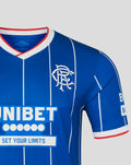Rangers blue home shirt close up of left chest with crest and Umbro logo against a pinstripe background