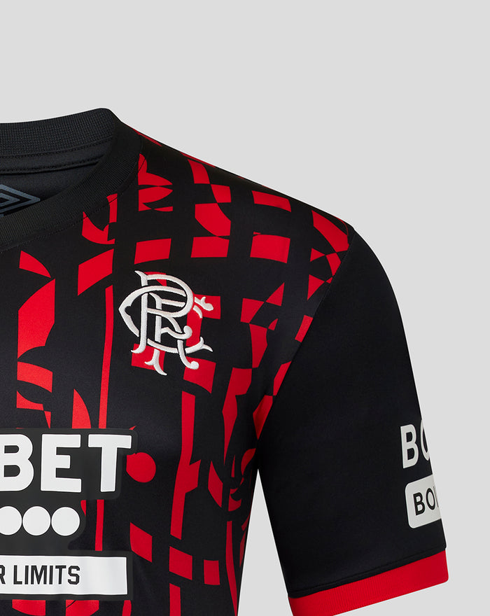 Front chest view of Rangers FC 2026/27 third shirt with crest and bold red geometric pattern on black fabric