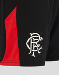 Close-up of black Rangers FC shorts showing white crest on lower right leg and red side panel